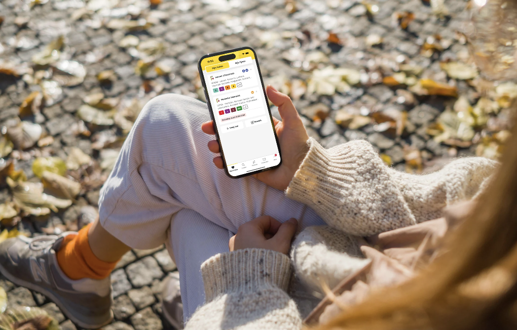 woman sitting on bench looking at her mobile phone
