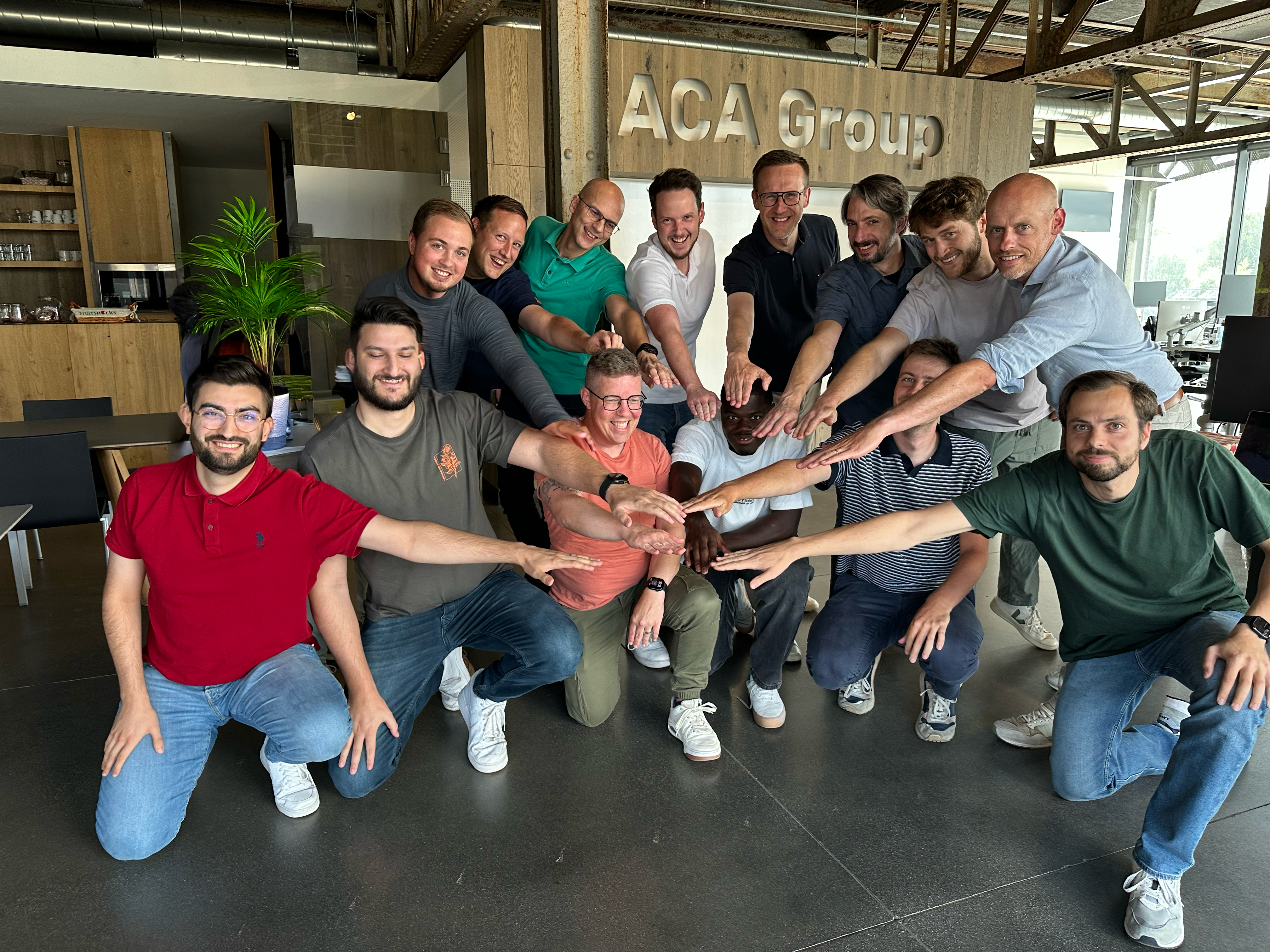 team of 14 people posing for a photo