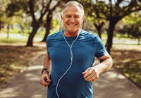 Old man jogging listening to music