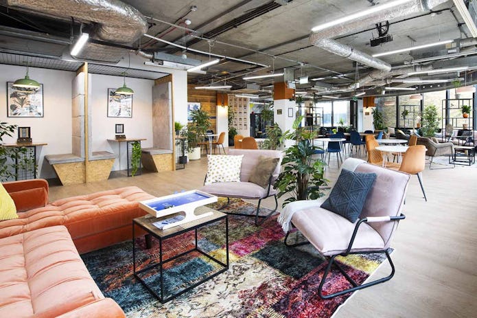 A colourful breakout space in the Runway East Borough Market office with comfy chairs and plants everywhere