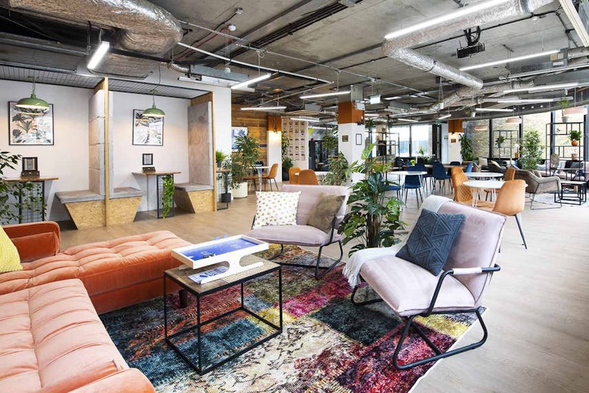 A colourful breakout space in the Runway East Borough Market office with comfy chairs and plants everywhere