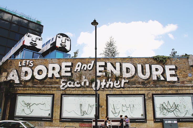 https://www.datocms-assets.com/46385/1650900829-shoreditch-graffiti-adore-and-endure-each-other.jpg?auto=format&fit=max&q=50&w=735