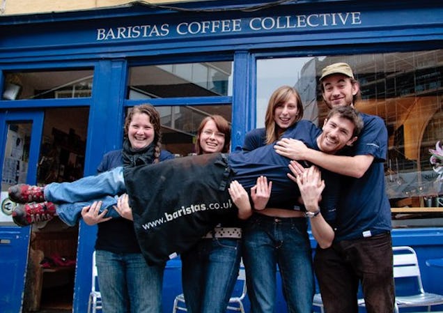 Baristas coffee collective staff members pose for photo.