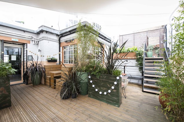 A photo of the Runway East Soho terrace, with seating and plants.