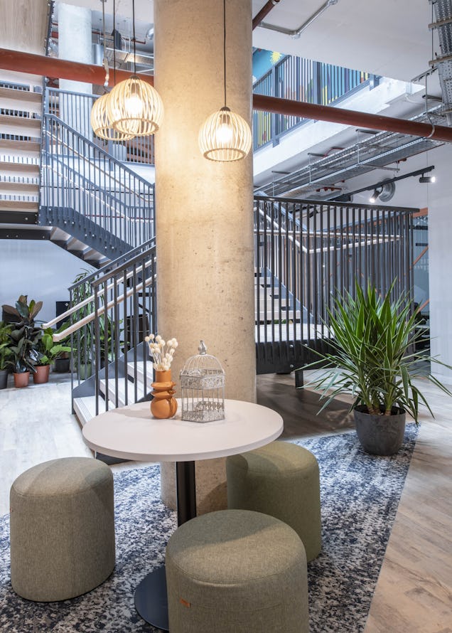 A photo of a breakout space at Runway East Brighton with a small table and stools.
