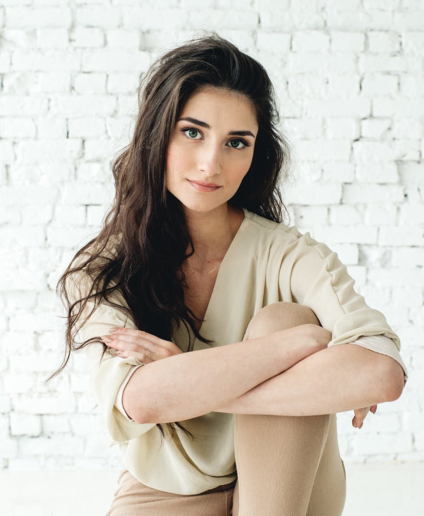 woman with dark hair in ivory sweater