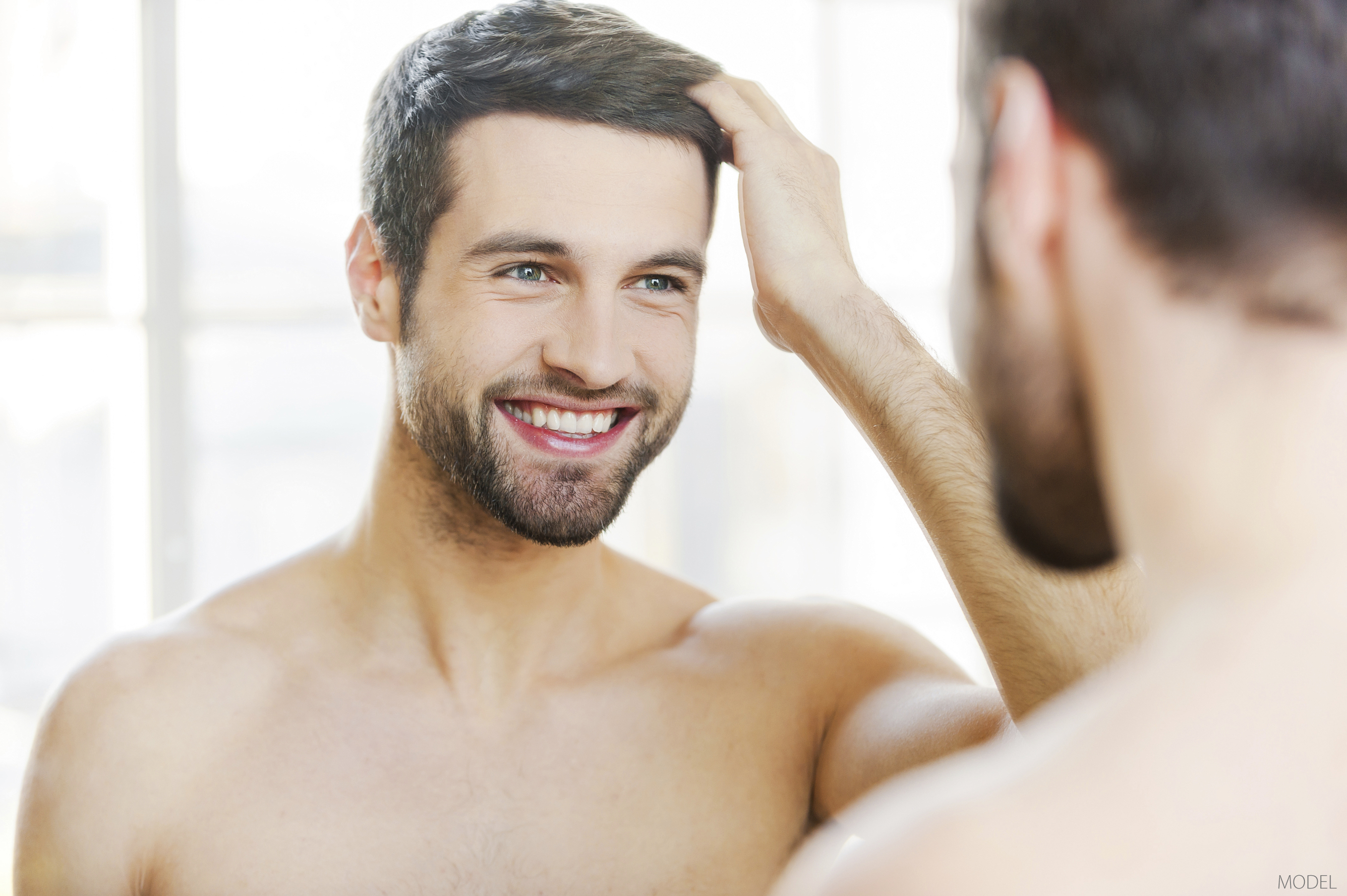 A patient is happy with his hair restoration results