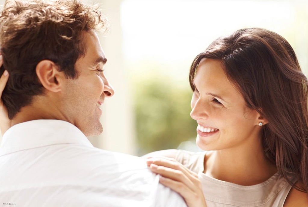 Woman admiring boyfriends hair after hair restoration in Hawaii