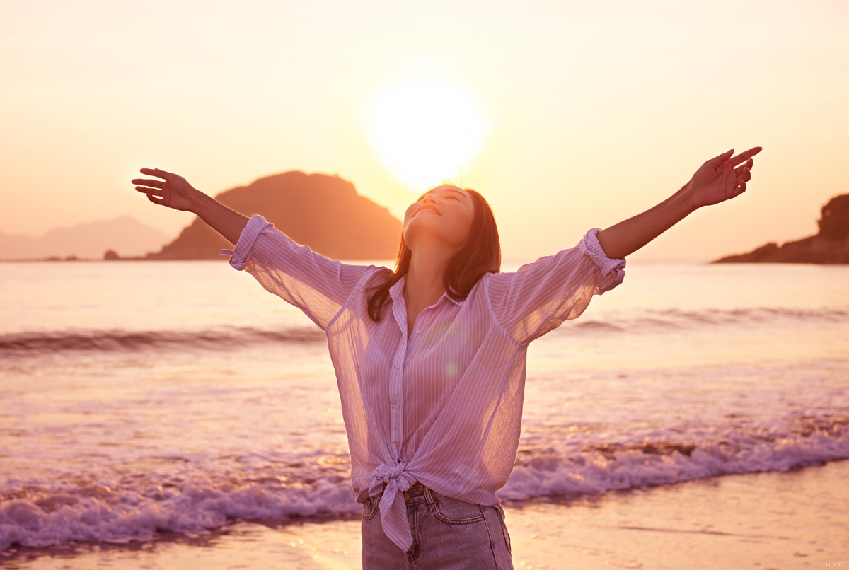 A woman is happy after getting breast revision surgery.