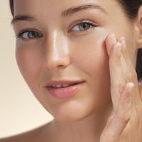 woman with hand on face