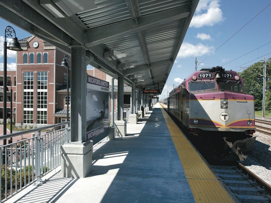 Photo of a train station with a train on the platform in Boston