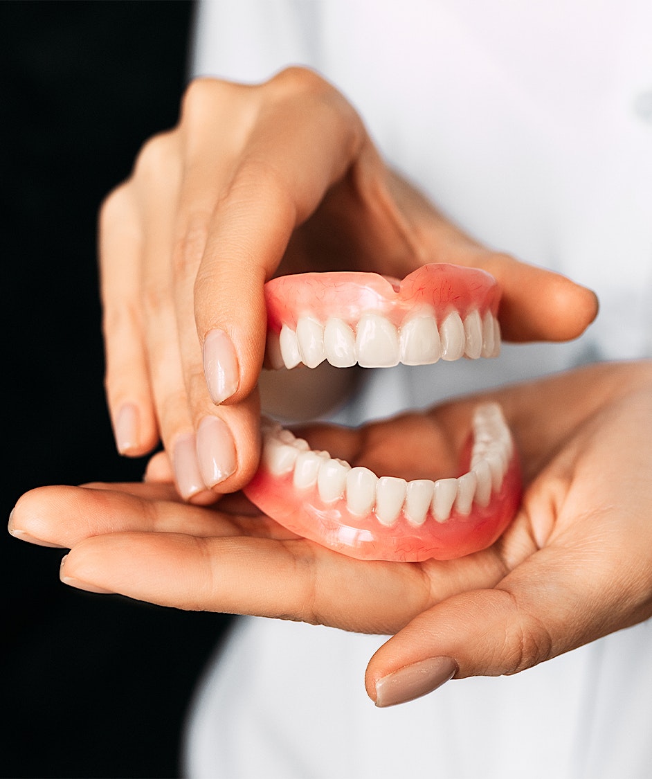 person holding dentures