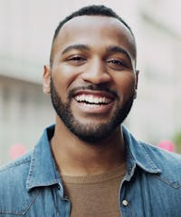 Handsome man smiling outside