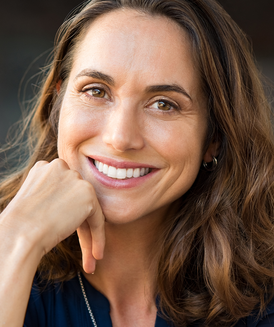 Woman with long brown hair smiling