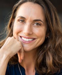 Woman with long brown hair smiling