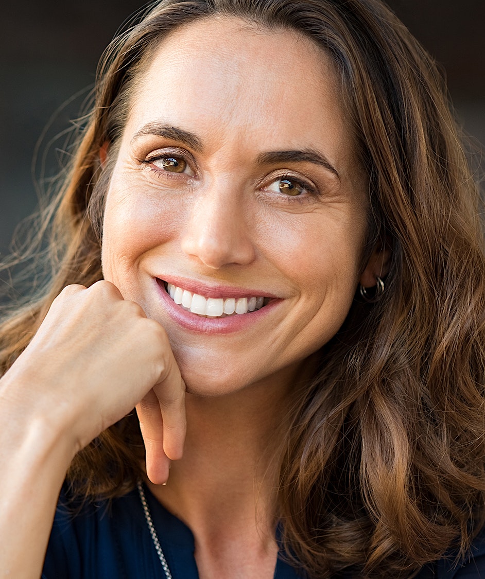 Woman with long brown hair smiling