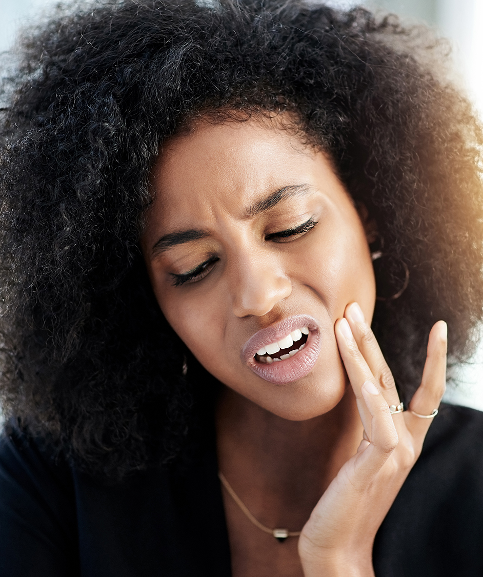 Woman in pain, touching her jaw