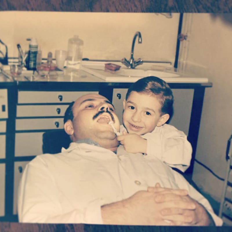 child and adult with dental equipment