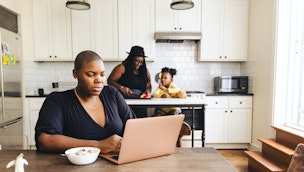 woman-on-computer-in-kitchen