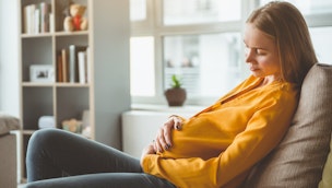 pregnant-woman-sitting-on-sofa