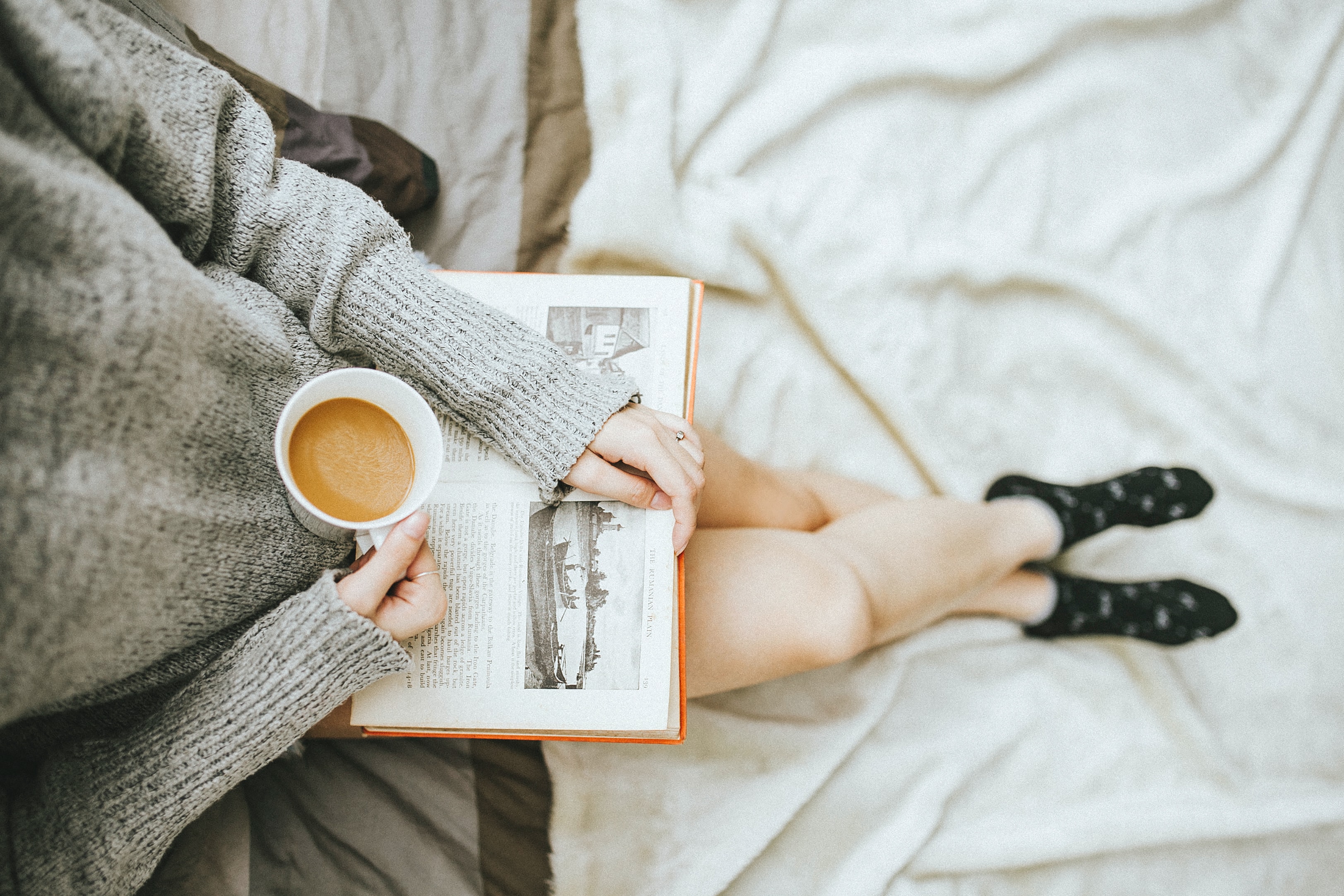 woman-holding-coffee-and-book