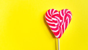 heart-shaped-lolly-yellow-background