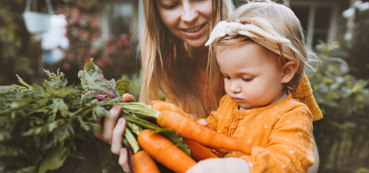 A plant-based diet prioritizes whole foods. mother-and-child-with-carrots