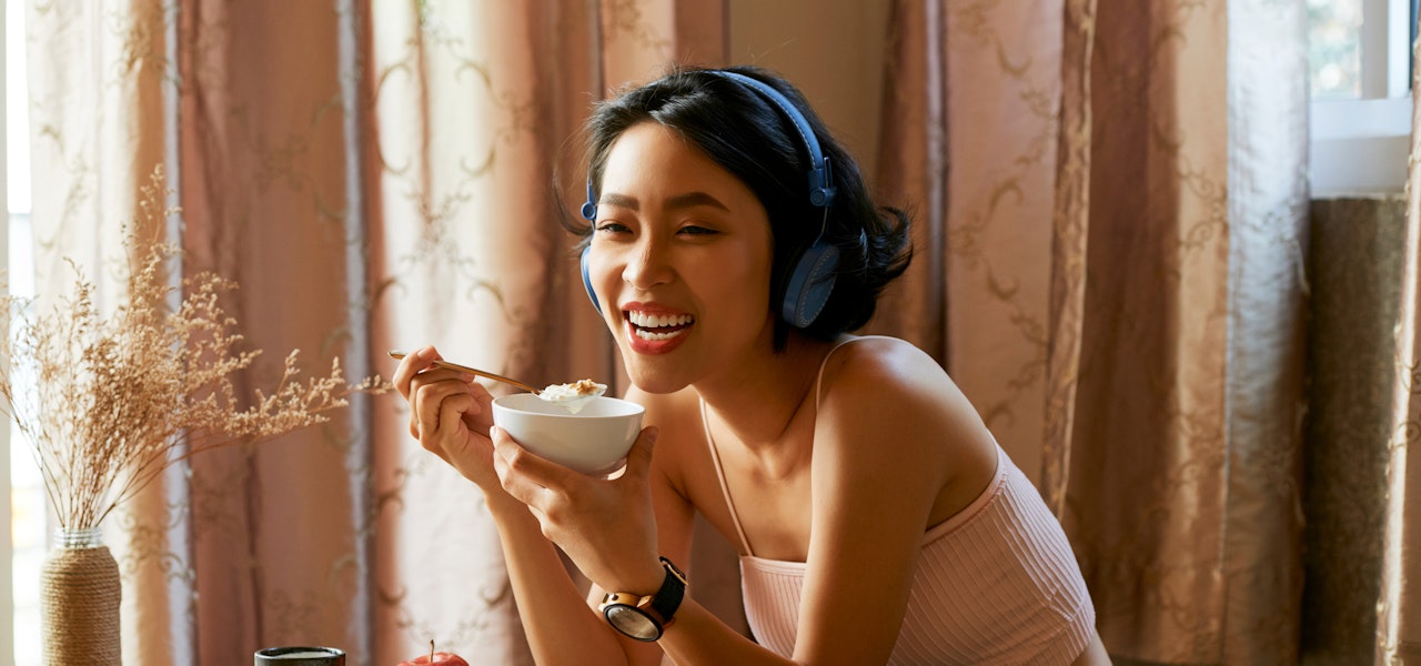 woman-eating-yogurt-and-smiling