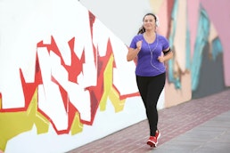 a person jogging next to street art