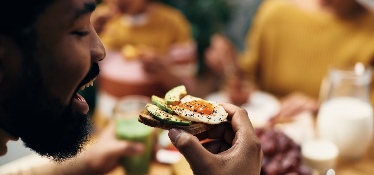 man-eating-avocado-egg-toast