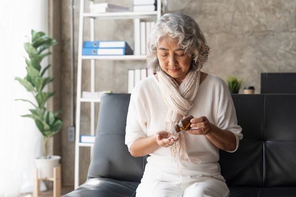 older-woman-taking-pills