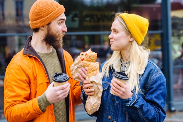 people-in-warm-hats-eating-sandwiches