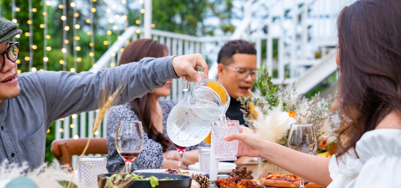 pouring-water-at-an-outdoor-dinner-party