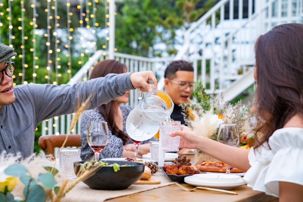 pouring-water-at-an-outdoor-dinner-party