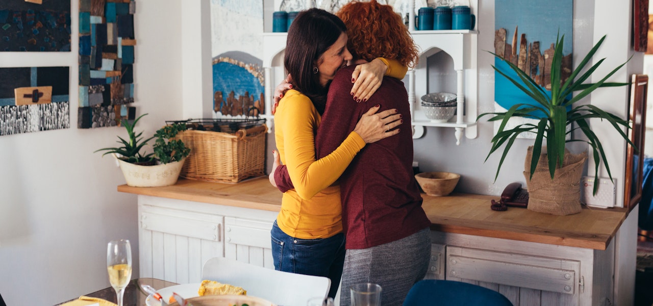 hugging-at-a-dinner-party