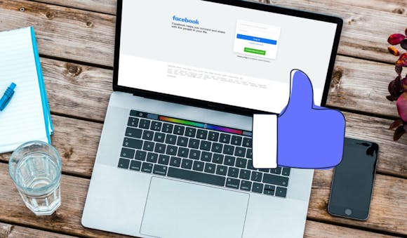 blogpost-image of a laptop displaying a facebook log in screen and a tumbs up icon