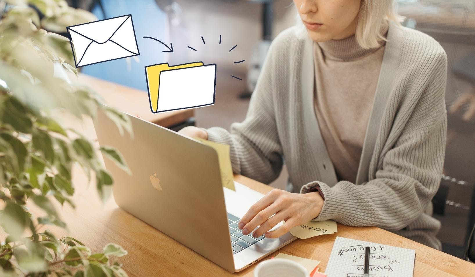 Blogpost image of a women behind her laptop with a note book and sticky notes being orgainized. There is a StartMail illustration of an envelope going into a folder that symbolised StartMail's filter feature.