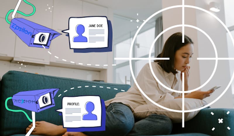 A relaxed woman reclines on a couch and looks at her phone, unaware that there are two animated surveillance cameras, with the logos of data brokers Epsilon and Acxiom, pointed at her, placing a giant target on her, and forming digital profiles of her