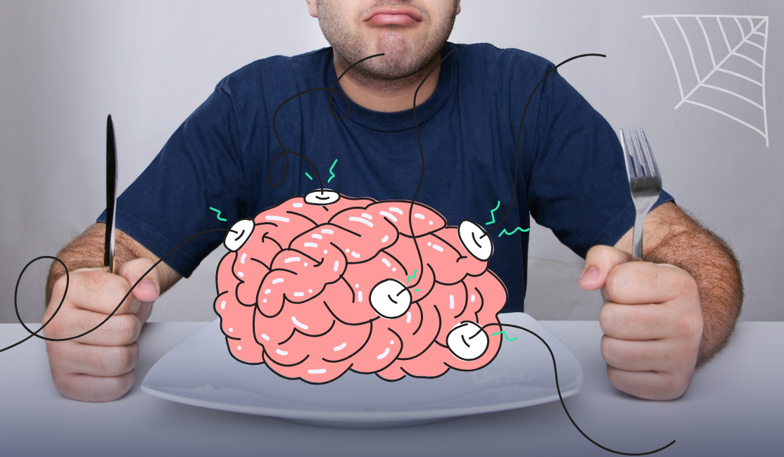 A person sits down at a dinner table with a knife and fork. On the plate in front of him is a brain hooked up to electrodes.
