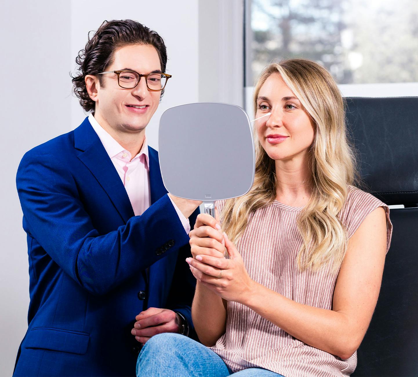 Dr. Frankel, Cleveland Facial Plastic Surgeon, with a female during a rhinoplasty consultation