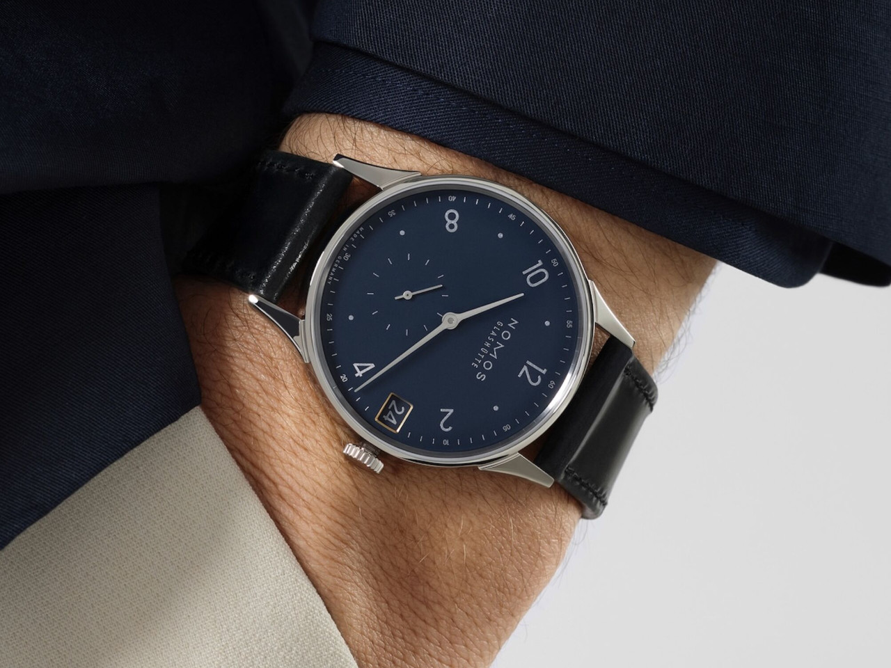 NOMOS Glashütte Minimatik 39 Datum Handaufzug Edelstahl blaues Zifferblatt schwarzes Lederband am Handgelenk