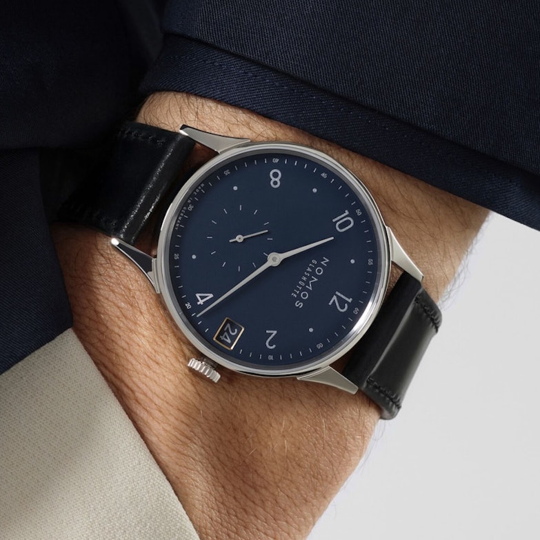 NOMOS Glashütte Minimatik 39 Datum Handaufzug Edelstahl blaues Zifferblatt schwarzes Lederband am Handgelenk