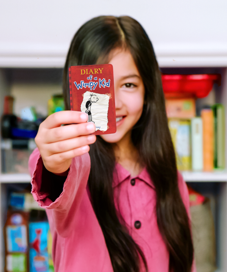 Girl holding a Wimpy kid card
