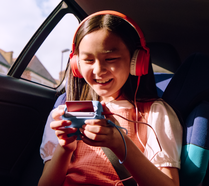 Child using Yoto Mini in the car