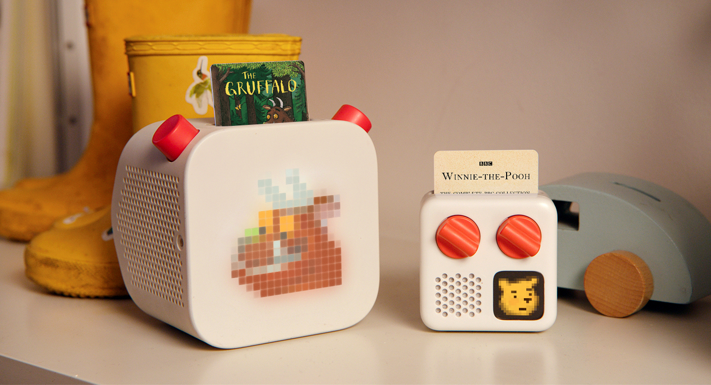 Yoto Player and Yoto Mini on a shelf next to children's toys