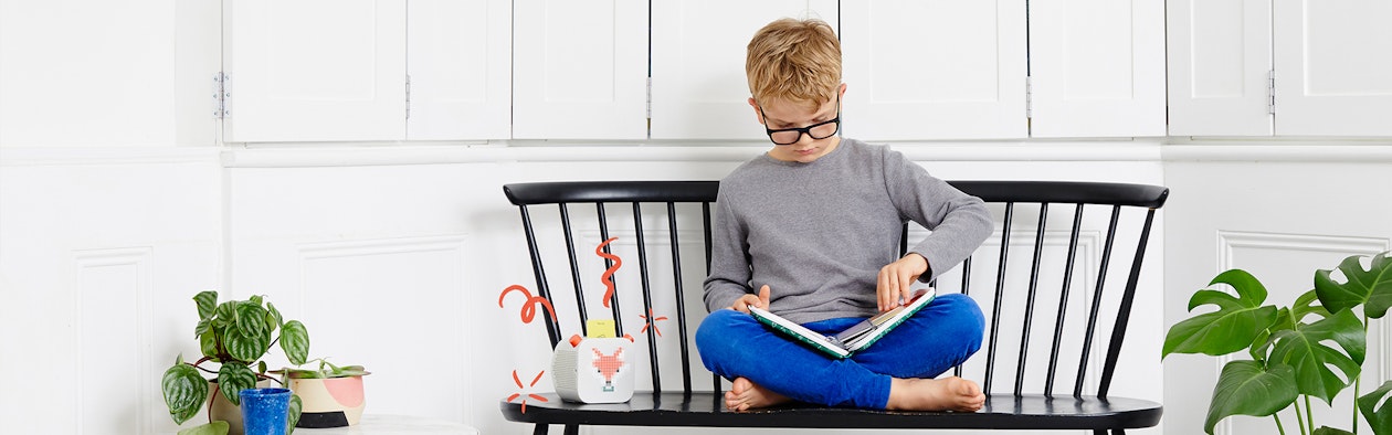 Child reading with Yoto Player