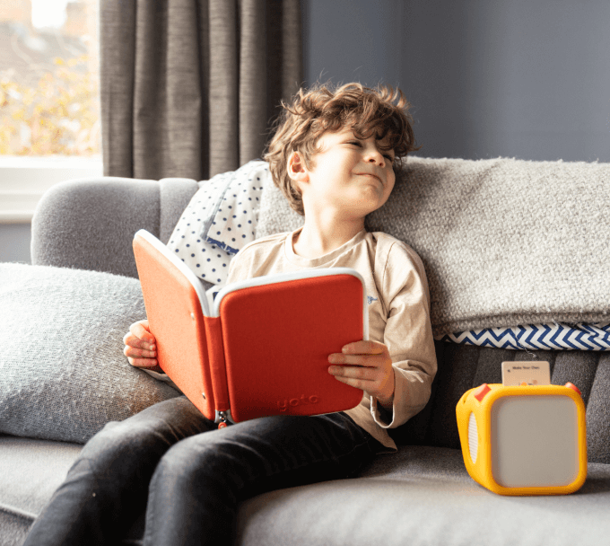 child holding a yoto card case