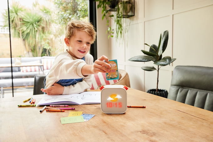 Child putting card into Yoto Player