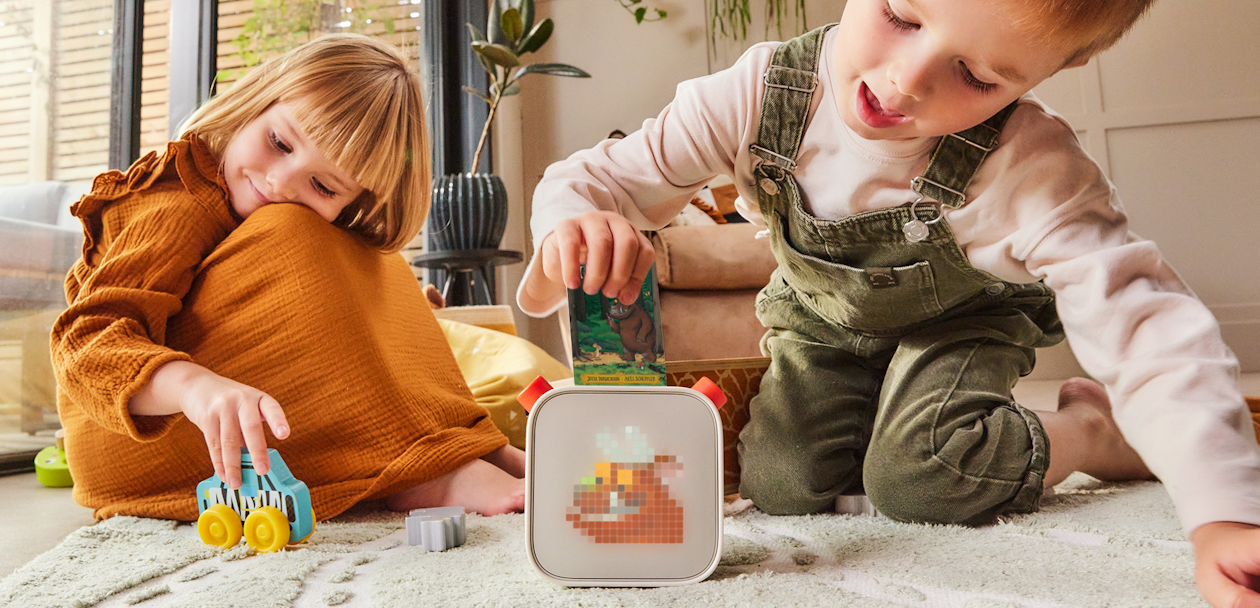 Two kids playing with a Yoto Player