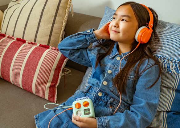 Child listening to Sea Defenders in Mini